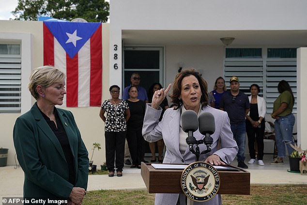 US Energy Secretary Jennifer Granholm (L) listens as Vice President Kamala Harris speaks during a visit to Canovanas, Puerto Rico,