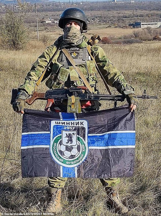 CSKA Spanish Battalion supporter Stanislav 'Spaniard' Orlov, photographed with a Shinnik Yaroslavl FC flag and an RPK light machine gun, reportedly in occupied Donetsk Oblast