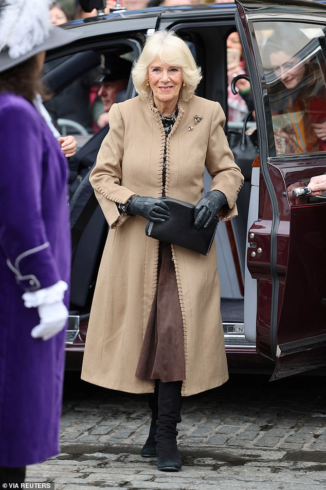 Britain's Queen Camilla smiles as she arrives for her visit to the farmers market, in Shrewsbury.
