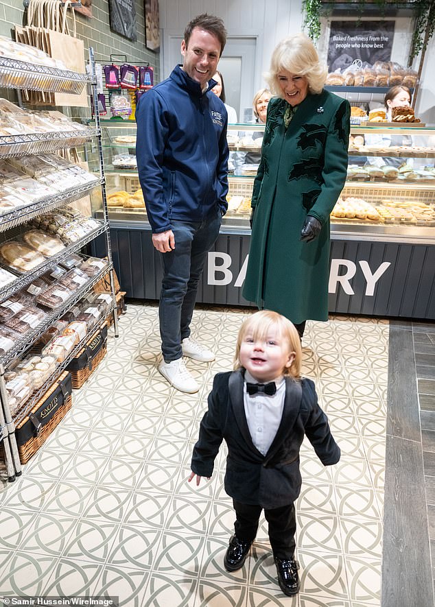 Queen Camilla was photographed by an adorable one-year-old boy as she visited local shops during a visit to Belfast on Thursday.