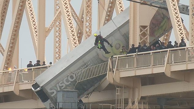 First responders were seen rappelling off the side of the Clark Memorial Bridge as the driver dangled dangerously over the water.