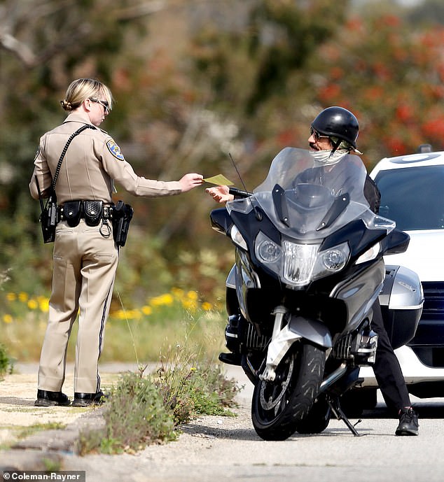 DailyMail.com saw musician Anthony Kiedis, 61, receiving a ticket from a California Highway Patrol officer for running a red light.