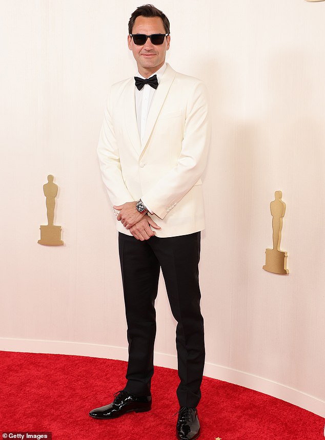 Roger Federer attends the 96th Annual Academy Awards in a dapper black and white tuxedo