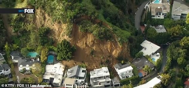 Three homes in Hollywood Hills, California, were damaged by a landslide (pictured) on Sunday after torrential rains caused significant ground movement.