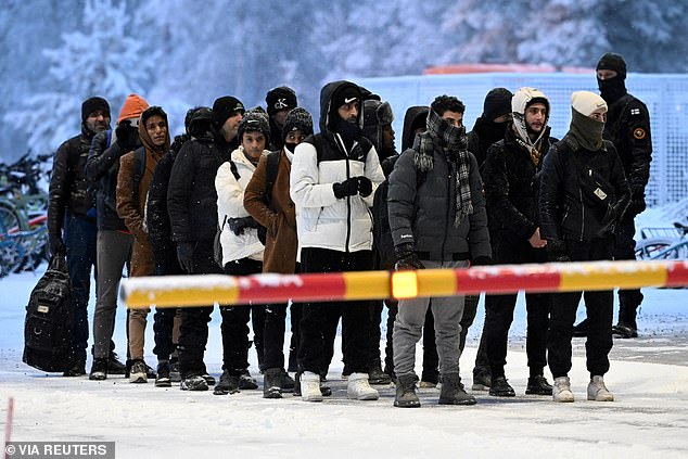 A group of asylum seekers arrives at the Salla border, northern Finland, in November 2023, amid a migration crisis driven by Russia