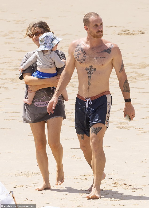 During the outing, Sam was every inch the doting mother, cuddling her sweet little son as they strolled along the sand.