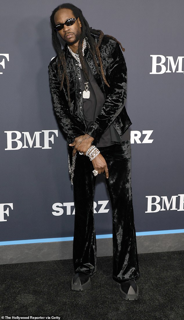 Rapper 2 Chainz, 46, wore a crushed velvet ensemble with multiple silver chains.