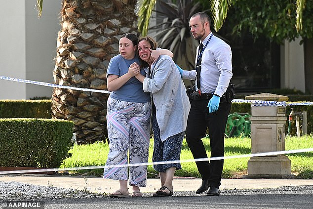 A woman pictured outside the Greenvale home where Melbourne greengrocer John Latorre was found dead early on Tuesday morning appeared distressed