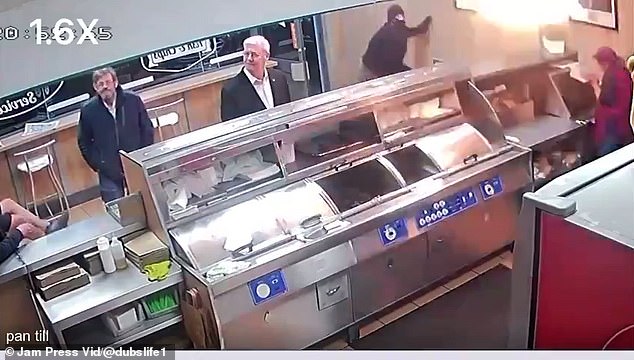 A man wearing a balaclava threw a flaming petrol bomb into a fish and chip shop as hungry elderly customers waited for their takeaway dinners (pictured)