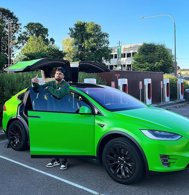 Tennis ace Nick Kyrgios, 28, with his lime green Tesla (pictured) which was stolen in May last year.  Kyrgios helped police track it using the Tesla app that also limited the car's speed.