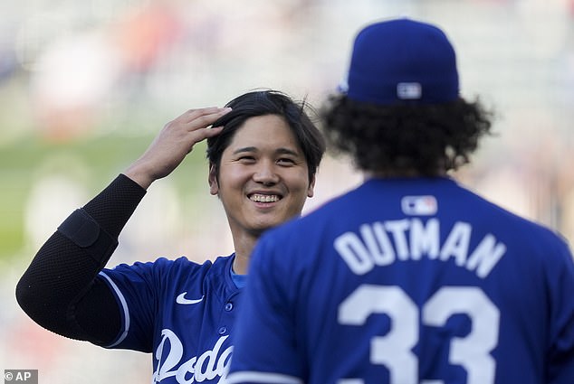 Shohei Ohtani jokes with Dodgers teammate James Outman before Tuesday's exhibition