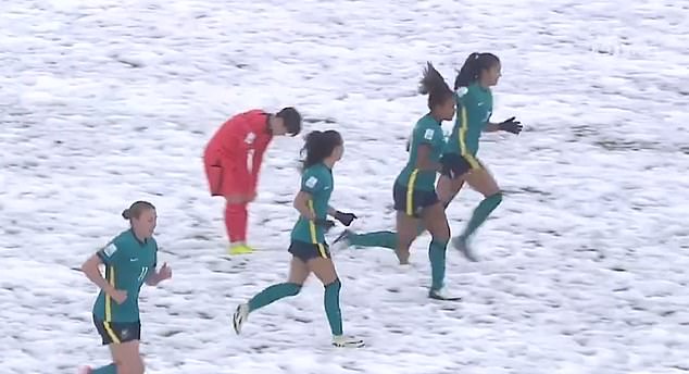 The Australian women celebrate in the snow after their victory over Korea Republic in Uzbekistan.