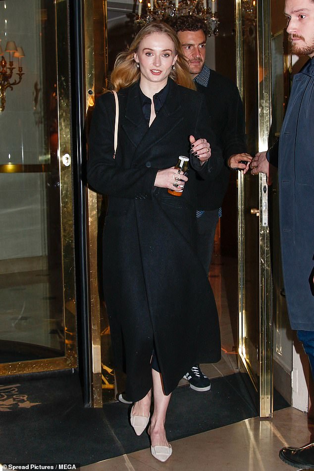 Sophie Turner, 27, bundled up in a stylish black coat while out in Paris with her new boyfriend Peregrine Pearson, 29, on Sunday.