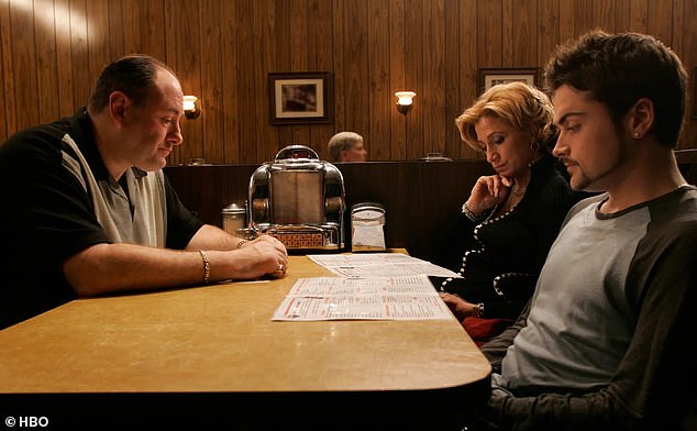 The restaurant table used in the final scene of The Sopranos in Bloomfield, New Jersey, is up for auction on Ebay until Monday, March 4 at 10 pm;  Members of the Soprano family sitting in the booth at the end included the late James Gandolfini (Tony), Edie Falco (Carmela) and Robert Iler (AJ), as they waited for Jamie-Lynn Sigler (Meadow) to join them.