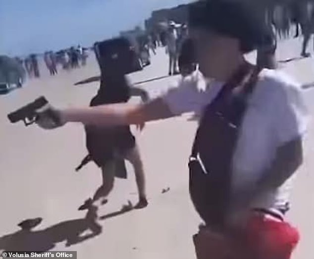 In shocking footage, Solis-Guzman can be seen brawling with four people on the crowded beach before pulling out a firearm