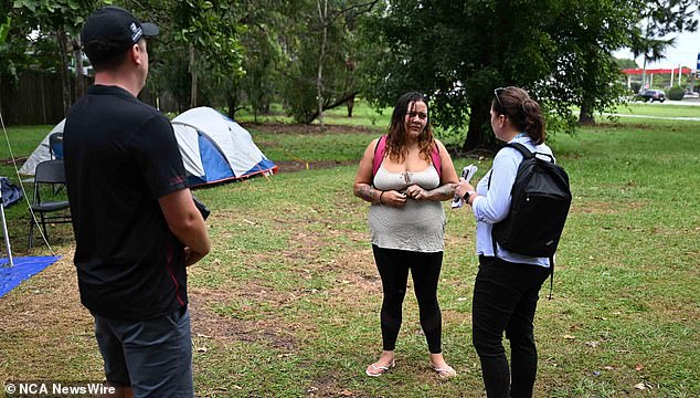 MccGill said while people living in the park may be homeless, that doesn't mean they haven't been trying to get back on their feet (pictured, a woman speaking to staff from the Queensland state government's housing department).
