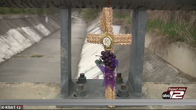 San Antonio police officers found the missing woman's jacket and later her naked body under a bridge in a drainage ditch on Oak Dell Drive. A cross (pictured) was placed on the spot where the murder took place