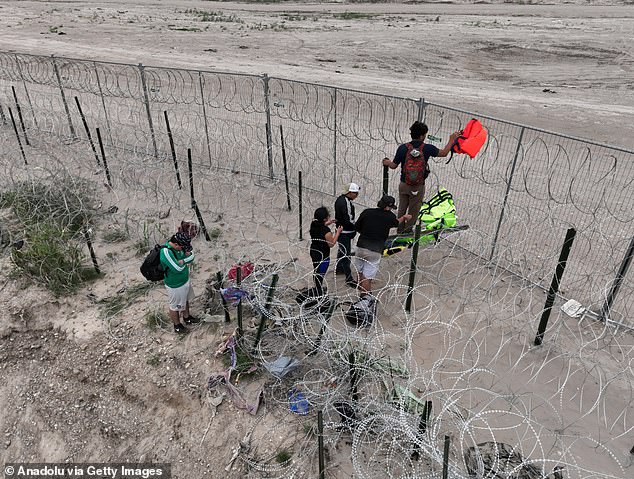Migrants crossing the border at Eagle Pass from Mexico. Both Biden and Trump headed to the southern border on Thursday for opposing events as polls show immigration is a major issue among voters in swing states.