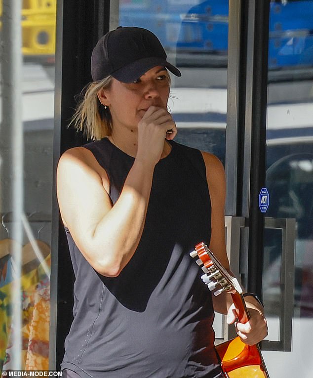Sarah Harris looked every inch the boho rock star on Thursday when she was spotted walking around the trendy Melbourne suburb of South Yarra with a guitar and a vaporizer.