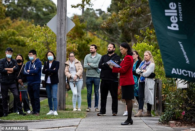 The average Australian worker can no longer afford to buy a home in any major city without facing mortgage problems, new research shows (pictured, Melbourne auction)