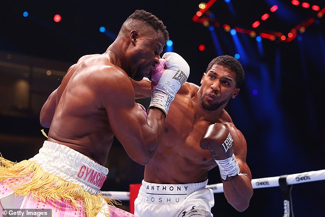Joshua (right) dropped his opponent three times in the first two rounds, landing a brutal right hook at Ngannou (left), knocking out his opponent.