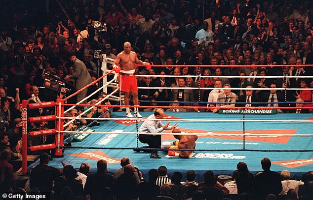 George Foreman (left) became the oldest heavyweight champion to win a world title after his brutal knockdown over Michael Moorer.