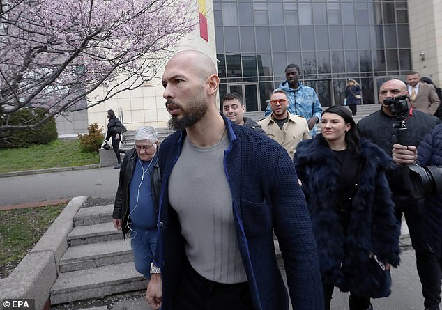 Andrew Tate pictured leaving court in Bucharest, Romania on Friday after a hearing;  MailOnline can reveal that two women asked to be 'declassified' as victims