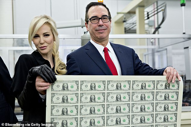 Donald Trump's former Treasury Secretary Steve Mnuchin has revealed that he is gathering a group of investors to try to buy TikTok.  He is pictured with his wife Louise Linton in 2017