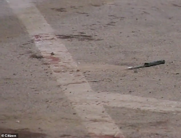 A knifeman was photographed in a cordoned off area of ​​the bloodied street shortly after.