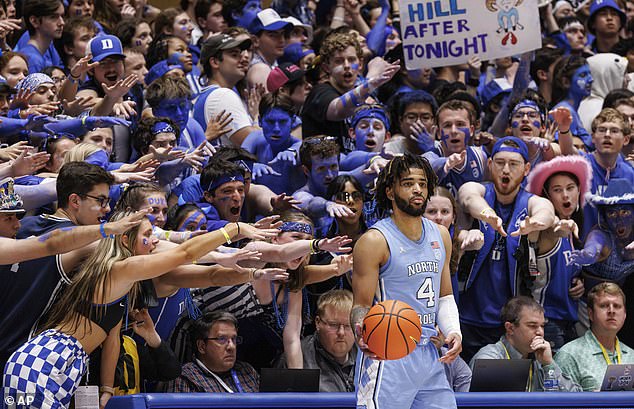 North Carolina's RJ Davis (4) inbounds on the ball in front of the Duke student section