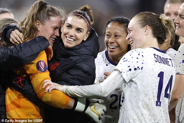 Alyssa Naeher of the United States celebrates with teammates, including Alex Morgan