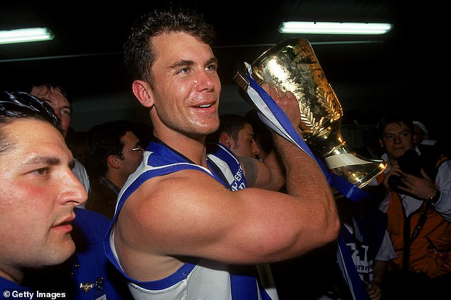 Carey won AFL premierships with the Kangaroos in 1996 (pictured) and 1999.