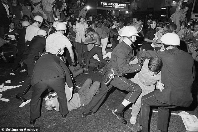 Nearly six decades ago, delegates gathered inside the International Amphitheater in the Windy City to nominate Hubert Humphrey for president, but chaos reigned outside.  (Above) Police and protesters clash near the Conrad Hilton Hotel on Chicago's Michigan Avenue on August 28, 1968 during the Democratic National Convention.