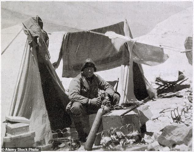 Andrew Comyn Irvine, the British climber, is pictured working with an oxygen bottle at the Everest Expedition camp in 1924.