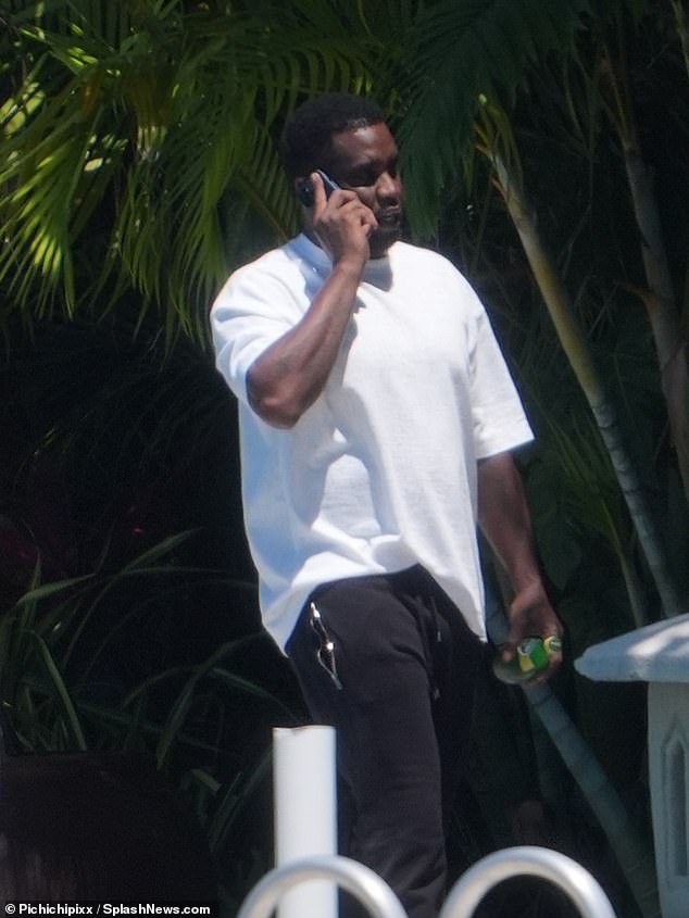 Diddy was seen taking a call outside his Star Island mansion in Miami Beach, Florida, on Easter Sunday, days after the FBI raided his homes.