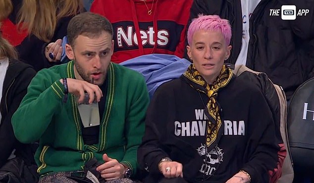 Rapinoe, 38, sat next to Tommy Alter to watch the NBA game