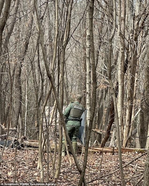 A Kentuck police officer is pictured searching for Sebastian at a landfill ten days after he went missing