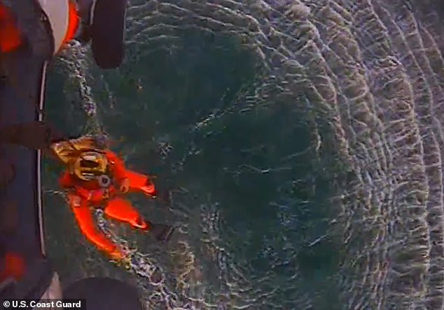 Once rescuers spotted him, a man prepared himself just before going down into the water to save Smelley 11 hours later.