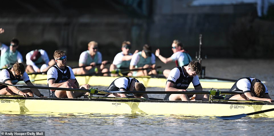 Oxford's despondent crew slumped in their boats as Cambridge toasted their achievement in the background.