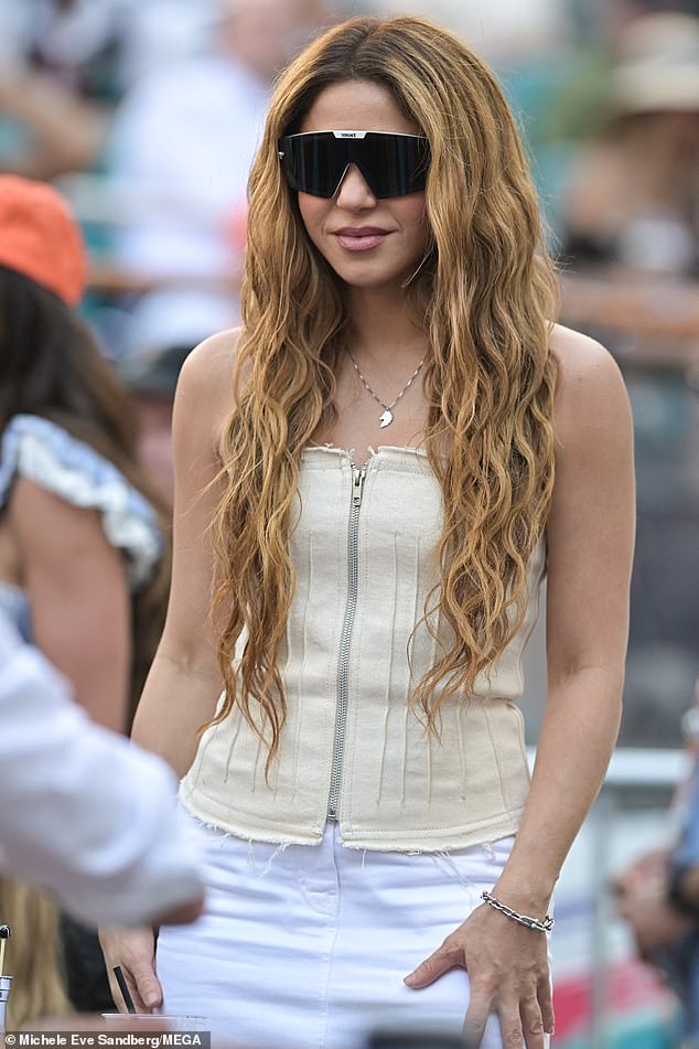 Shakira looked chic for her day in double denim, sporting a cream zip-up corset and a white miniskirt.