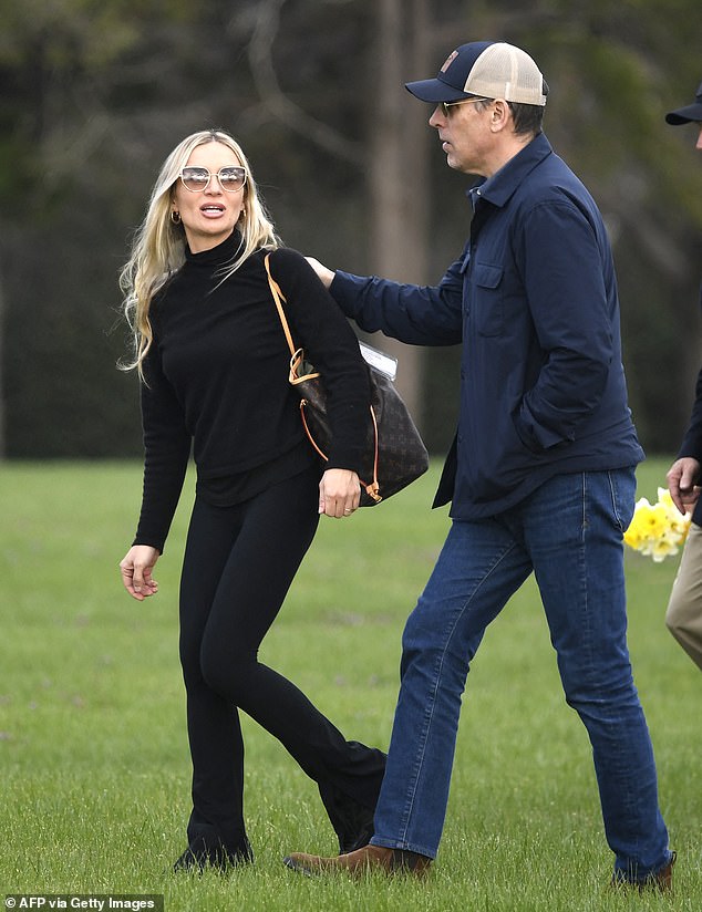 Beau Biden's parents, Hunter Biden and Melissa Cohen, kept it casual with the president's son wearing jeans and a dark blue shirt and his wife smiling behind a pair of large sunglasses.