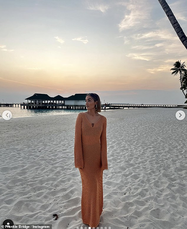 Another one of her incredible looks included an orange semi-sheer embroidered beach dress from Pretty Lavish, paired with chunky earrings as the star posed in front of the sunset.
