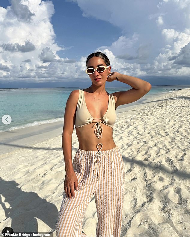 The singer also rocked another stylish look as she rocked a beige Riotswim bikini top with a bow on the front. with Topshop beach pants