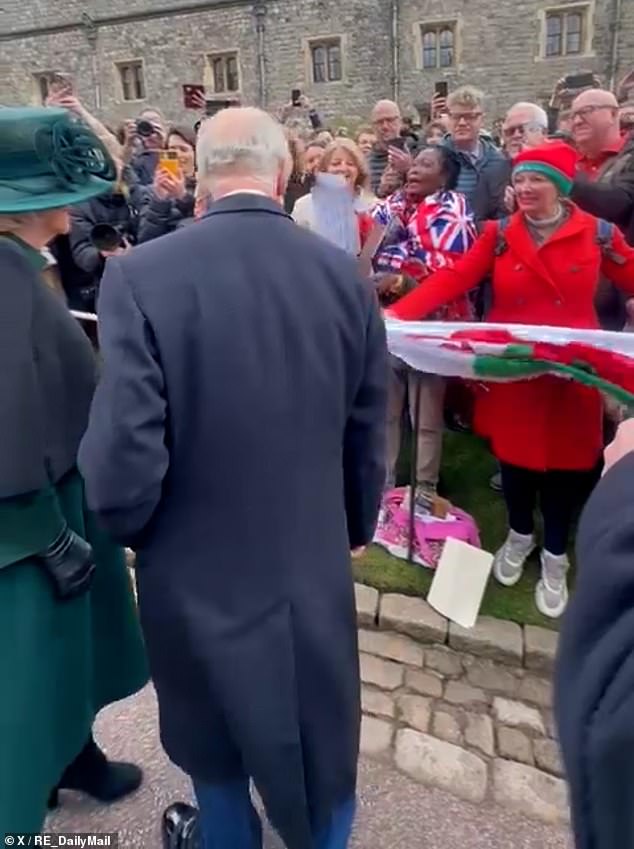 A woman, who was holding a Welsh flag and wearing a matching bright red coat and hat, called out to King to get his attention.