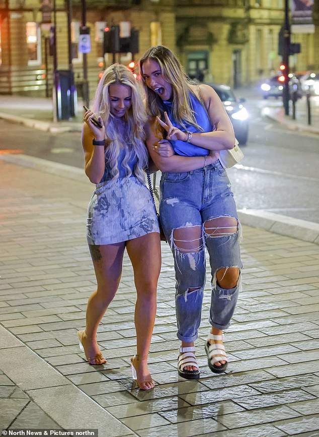 Two friends pose for the cameras as they venture into Newcastle for a night out on Easter Sunday.