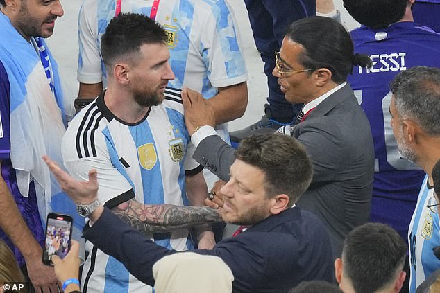 Salt Bae (right) puts his hand on the shoulder of Argentina's Lionel Messi at the end of the World Cup soccer final.