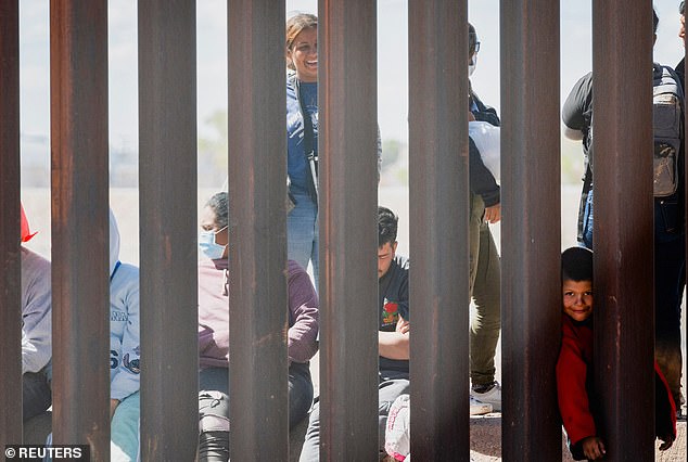 The migrant families who were part of the mob of 600 people are waiting to be processed by the US Border Patrol.