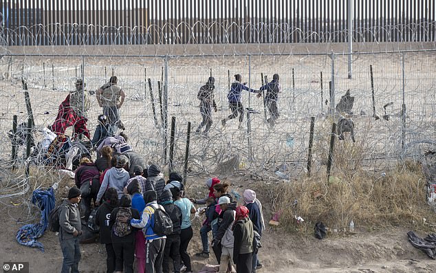 Migrants violate infrastructure established by the Texas National Guard on the Rio Grande in El Paso, Texas, on Thursday.