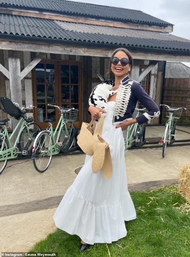 The Marchioness of Bath smiles as she snuggles up to a black and white rabbit at Soho Farmhouse, a members' club and hotel in Oxfordshire.