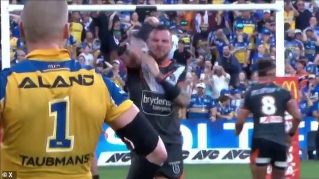 The allegation comes as the veteran forward was also arrested making an obscene gesture (pictured) towards Eels defender Clint Gutherson, who missed a penalty attempt after the full-time siren that would have won the game.